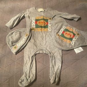 Gucci one piece with bib and hat worn once .
